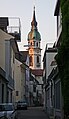 Steeple of Saint Nicholas Church seen from a backside alley