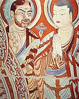 A blue-eyed Central Asian monk teaching an East-Asian monk, Bezeklik, Turfan, eastern Tarim Basin, China, 9th century; the monk on the right is possibly Tocharian,[145] although more likely Sogdian.[146][147]