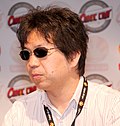 Man with sunglasses in front of a step and repeat