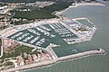 Aerial view of a typical marina (harbor dredge and lighthouse in lower right)