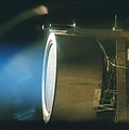 This image of a xenon ion engine prototype, photographed through a port of the vacuum chamber where it was being tested at NASA's Jet Propulsion Laboratory, shows the faint blue glow of charged atoms being emitted from the engine. The engine is now in an ongoing extended- life test, in a vacuum test chamber at JPL, and has run for almost 500 days (12,000 hours) and is scheduled to complete nearly 625 days (15,000 hours) by the end of 2001. A similar engine powers the New Millennium Program's flagship mission, Deep Space 1, which uses the ion engine in a trip through the solar system. The engine, weighing 17.6 pounds (8 kilograms), is 15.7 inches (40 centimeters) in diameter and 15.7 inches long. The actual thrust comes from accelerating and expelling positively charged xenon atoms, or ions. While the ions are fired in great numbers out the thruster at more than 110,000 kilometers (68,000 miles) per hour, their mass is so low that the engine produces a gentle thrust of only 90 millinewtons (20-thousandths of a pound).