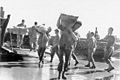 Supplies are unloaded manually from boats on Guadalcanal sometime between August, 1942, and February, 1943.