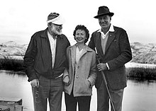 photograph of two men and woman