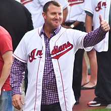 A baseball player in a white jersey