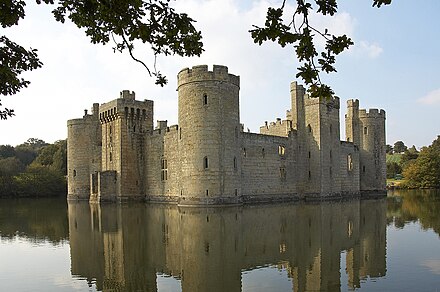 An English castle of square plan surrounded by a water-filled moat. It has round corner towers and a forbidding appearance.