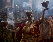 Women performing traditional Dhunachi ritualized dance worship by Bhuppigraphy