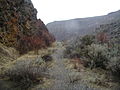 Old railroad bed and large rock cut where the train used to travel. 2006 photo