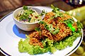 'Yam pladuk fu': "exploded" catfish with a spicy, sweet and sour green (unripe) mango dressing