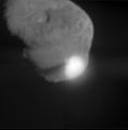 When NASA's Deep Impact probe collided with Tempel 1, a bright, small flash was created, which rapidly expanded above the surface of the comet. This flash lasted for more than a second. Its overall brightness is close to that predicted by several models. After the initial flash, there was a pause before a bright plume quickly extended above the comet surface. The debris from the impact eventually cast a long shadow across the surface, indicating a narrow plume of ejected material, rather than a wide cone. The Deep Impact probe appears to have struck deep, before gases were heated and explosively released. The impact crater was observed to grow in size over time. A preliminary interpretation of these data indicate that the upper surface of the comet may be fluffy, or highly porous. The observed sequence of impact events is similar to laboratory experiments using highly porous targets, especially those that are rich in volatile substances. The duration of the hot, luminous gas phase, as well as the continued growth of the crater over time, all point to a model consistent with a large crater. This image was taken by Deep Impact's medium-resolution camera.