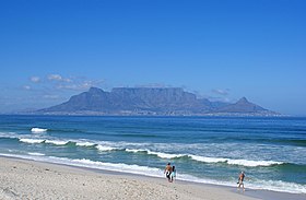 City of Cape Town at the foot of Table Mountain as seen from Bloubergstrand. The area around the city is famous for its plant biodiversity as illustrated in the foreground of the photograph.