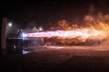 Picture of a rocket engine firing with blue-purple exhaust