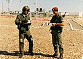 A Colombian soldier hosts a Canadian helicopter pilot 1989. The Colbatt soldier is wearing the distinctive "terracotta" beret that is unique to the MFO.