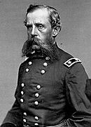 Black and white photo of a bearded man wearing a dark military uniform.