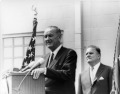 President Lyndon B. Johnson addresses space workers at Cape Kennedy, Florida, on September 15, 1964. NASA Administrator James E. Webb is in the background. (NASA photo 64-H-2365)