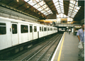 District line platforms in 1999. Note the crowded staircase behind the train.