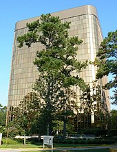 A color photograph of a large building covered with brass-colored windows