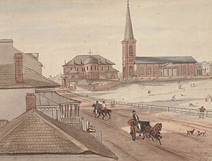 Watercolour of St James' next to the Supreme court. The view is looking north along an unpaved road (now Elizabeth Street) on which there are people walking, riding horses and driving carriages. An empty space (now Hyde Park) appears on the right hand side.