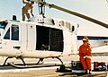 Canadian CH135 Twin Huey helicopter and an MFO Observer in her distinctive orange uniform 1989