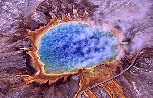 Surreal blue pool surround by orange border on a purple ground.