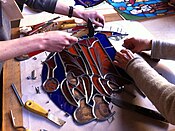 Musée de Cluny students at work in a stained glass workshop - assembling glass with came