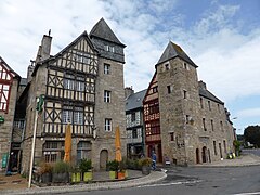 photo de l'entrée d'une ruelle médiévale. Les deux bâtiments d'entrée sont d'anciennes tours en pierres issues d'ancienne fortifications depuis disparues.