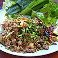 'Lap khua mu' is a northern Thai dish of chopped pork fried in chilli paste and served with fresh herbs and greens