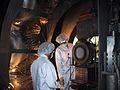 An ion thruster is removed from a vacuum chamber at NASA's Jet Propulsion Laboratory, Pasadena, Calif., its job done following almost five years of testing. Engineers John Anderson and Keith Goodfellow, from left, are part of JPL's Advanced Propulsion Technology Group. The thruster, a spare engine from NASA's Deep Space 1 mission, ran for a record 30,352 hours, giving researchers the ability to observe its performance and wear at different power levels throughout the test. This information will be vital to future missions that use ion propulsion. Ion propulsion systems can be very lightweight, running on just a few grams of xenon gas a day. This fuel efficiency can lower launch vehicle costs. Xenon is the same gas that is found in photo flash bulbs. The very successful Deep Space 1 mission featured the first use of an ion engine as the primary means of propulsion on a NASA spacecraft. NASA's next-generation ion propulsion efforts are led by the In-Space Propulsion Program, managed by the Office of Space Science at NASA Headquarters, Washington, D.C., and implemented by the Marshall Space Flight Center, Huntsville, Ala.. The program seeks to develop advanced propulsion technologies that will help near and mid-term NASA science missions by significantly reducing cost, mass or travel times. JPL is managed by the California Institute of Technology, Pasadena, Calif., for NASA.