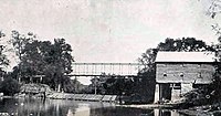 A view of Webers Mill, the mill dam, and iron bridge around 1910.