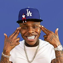 Cover art depicting DaBaby smiling and pointing finger guns at his head. He wears a baseball hat and a smaller animated version of himself is sitting on the brim.