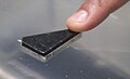 A visitor touching a lunar sample at the Kennedy Space Center Visitor Complex