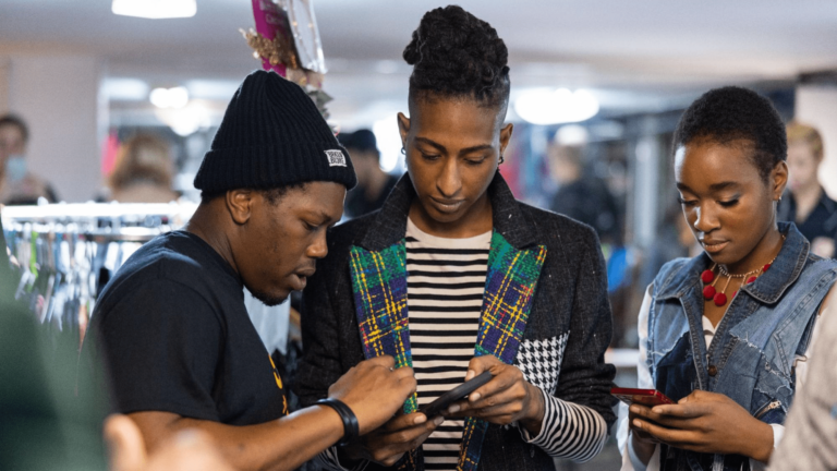 three people looking at phones