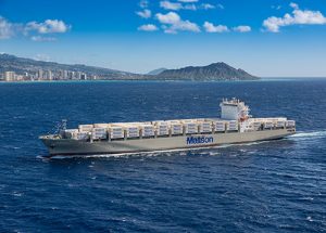 Aloha Class vessel DKI loaded with Matson containers and Diamond Head and Waikiki in the background.