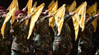 Hezbollah fighters attend the funeral of two people who died from exploding communication devices, a campaign blamed on Israel that has brought tensions to boiling point