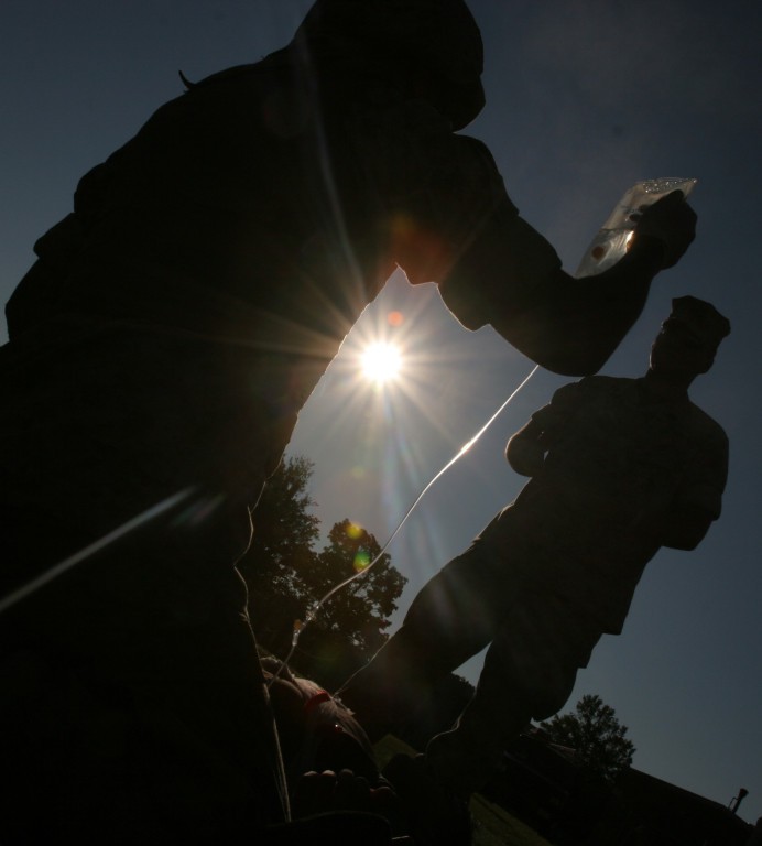 A corpsman preparing a soldier for medivac